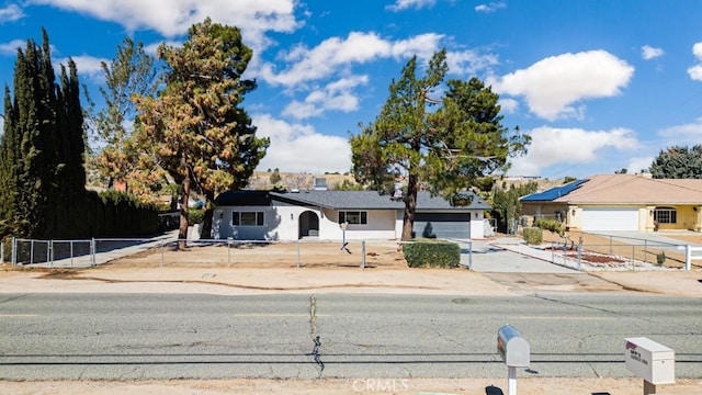 single story home featuring fence and concrete driveway