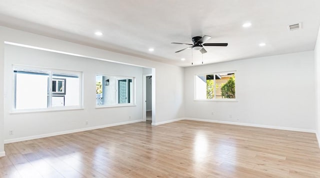 spare room with light wood-style floors, recessed lighting, and baseboards