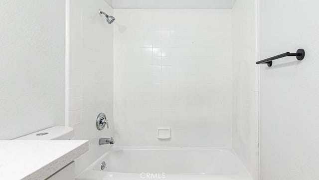 bathroom with shower / bath combination, toilet, and vanity