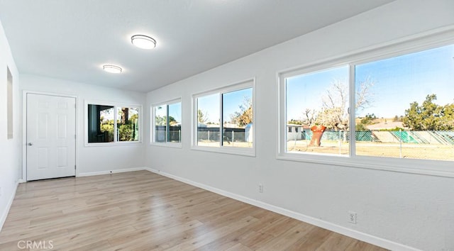 empty room featuring light wood-style floors and baseboards