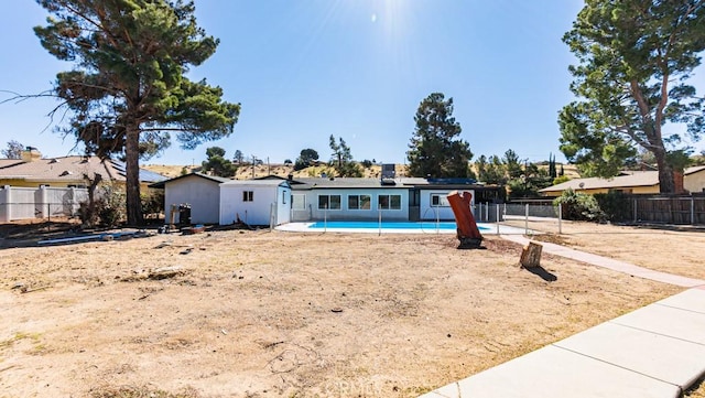 back of property with a fenced in pool and a fenced backyard