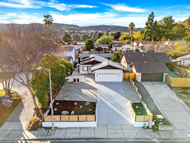 drone / aerial view featuring a residential view and a mountain view