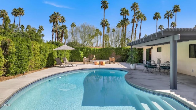 view of swimming pool with a fenced in pool, an outdoor fire pit, a patio, and a pergola