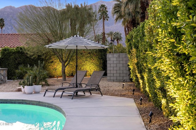 outdoor pool with a patio area and a mountain view