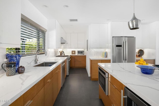 kitchen featuring stainless steel appliances, modern cabinets, and white cabinetry