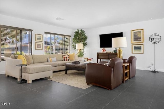 living area with visible vents and baseboards