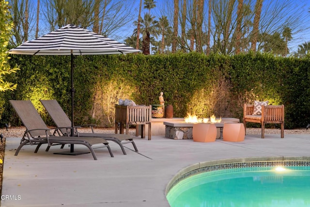 view of swimming pool with a fenced in pool, an outdoor fire pit, a patio area, and fence