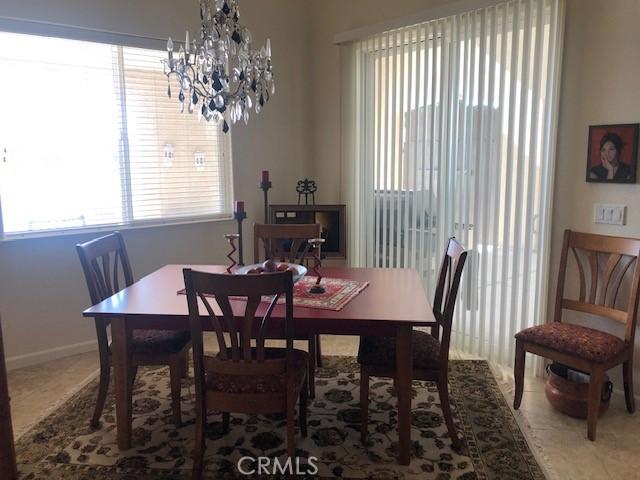 dining room with a chandelier and baseboards