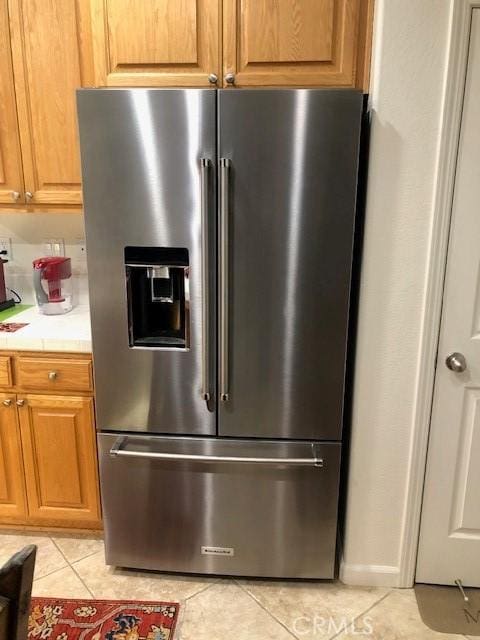 room details featuring brown cabinets, high end fridge, and light countertops