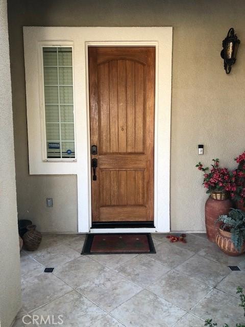 doorway to property featuring stucco siding