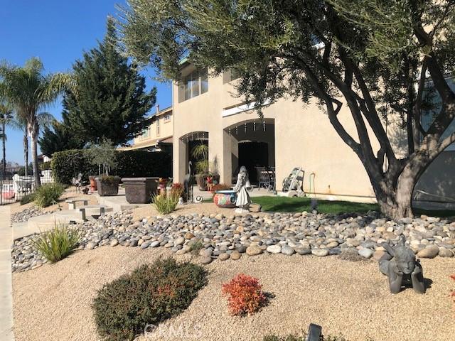 exterior space with a patio, fence, and stucco siding