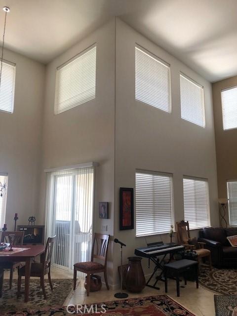 living room featuring a towering ceiling