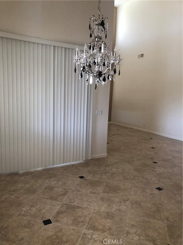 14510 Spyglass Cir, Chowchilla, CA 93610 - unfurnished room with a chandelier and baseboards