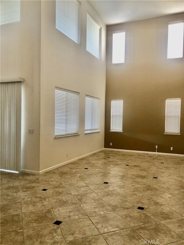 14510 Spyglass Cir, Chowchilla, CA 93610 - unfurnished room featuring a towering ceiling, baseboards, and tile patterned floors