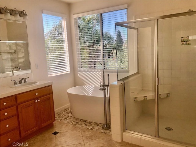 14510 Spyglass Cir, Chowchilla, CA 93610 - full bathroom with a stall shower, a freestanding tub, vanity, and tile patterned flooring