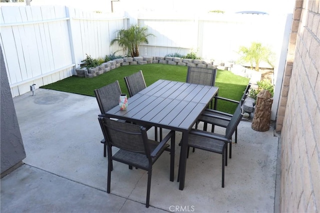 view of patio with a fenced backyard and outdoor dining space