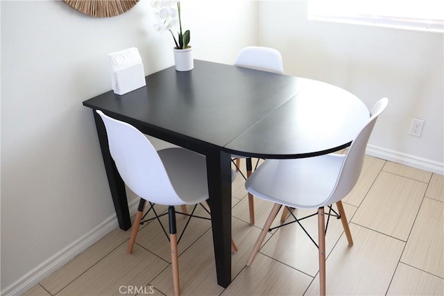 dining area featuring baseboards