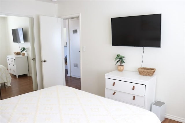 bedroom featuring dark wood-style flooring and visible vents