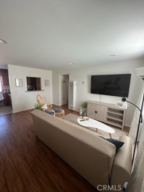 living area with dark wood finished floors and baseboards