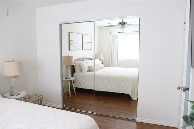 bedroom with dark wood-style flooring and a closet