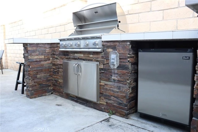 view of patio featuring exterior kitchen