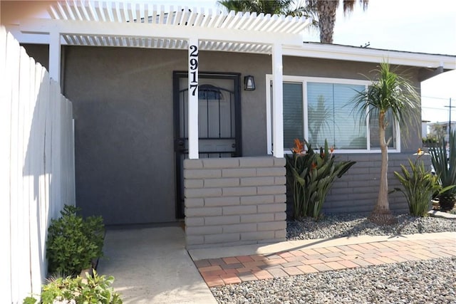 entrance to property with stucco siding