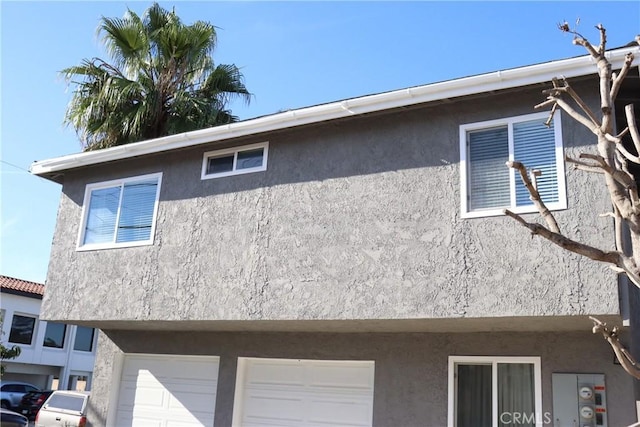 view of home's exterior featuring an attached garage and stucco siding