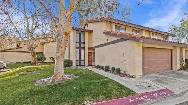 mediterranean / spanish-style house featuring an attached garage, driveway, a front yard, and stucco siding