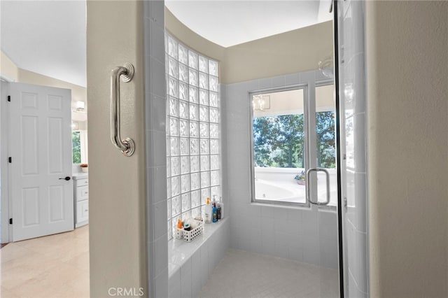 full bath with a washtub and tile patterned floors