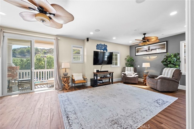 living room with a ceiling fan, baseboards, wood finished floors, and recessed lighting