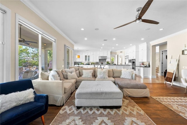 living area with recessed lighting, ceiling fan, crown molding, and wood finished floors