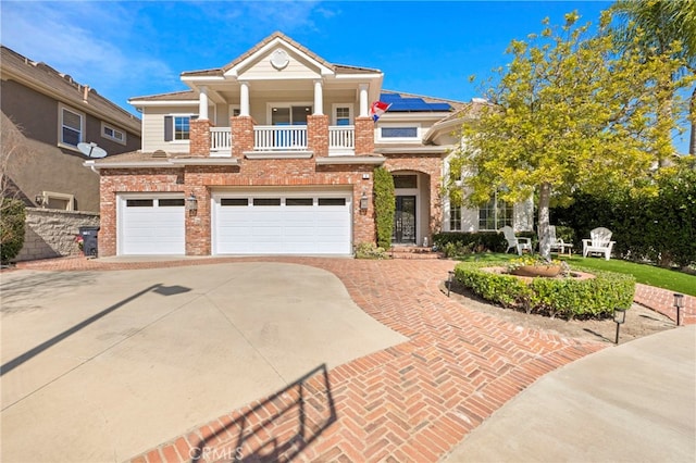 view of front of home featuring a garage, decorative driveway, and brick siding