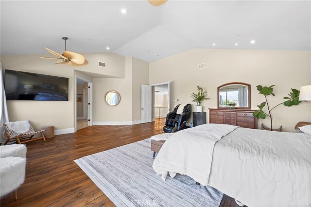 bedroom with vaulted ceiling, wood finished floors, visible vents, and baseboards