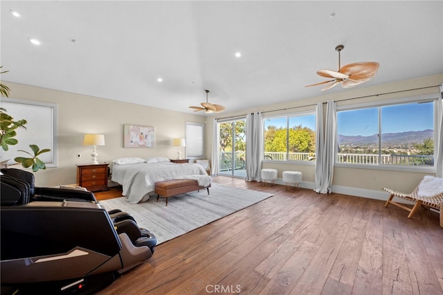 bedroom featuring lofted ceiling, ceiling fan, access to outside, baseboards, and hardwood / wood-style flooring