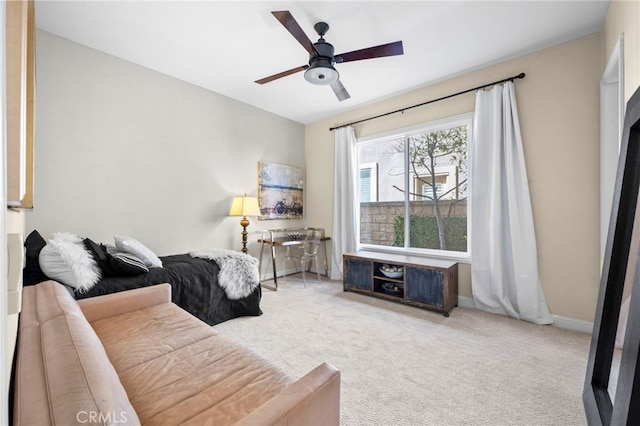 carpeted living room with ceiling fan and baseboards