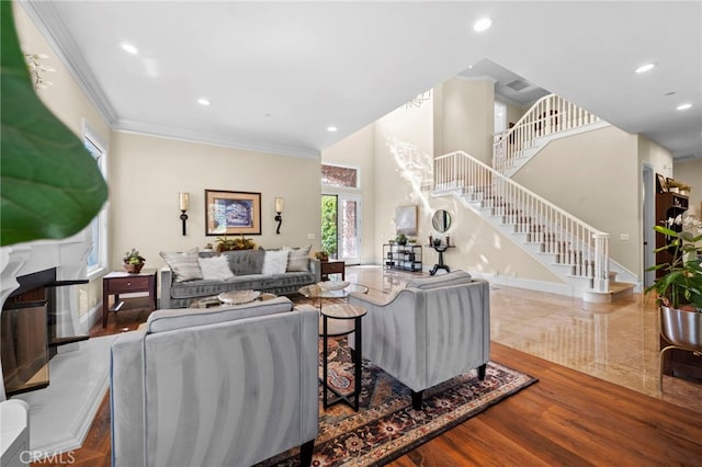 living area with recessed lighting, stairway, ornamental molding, a high end fireplace, and wood finished floors