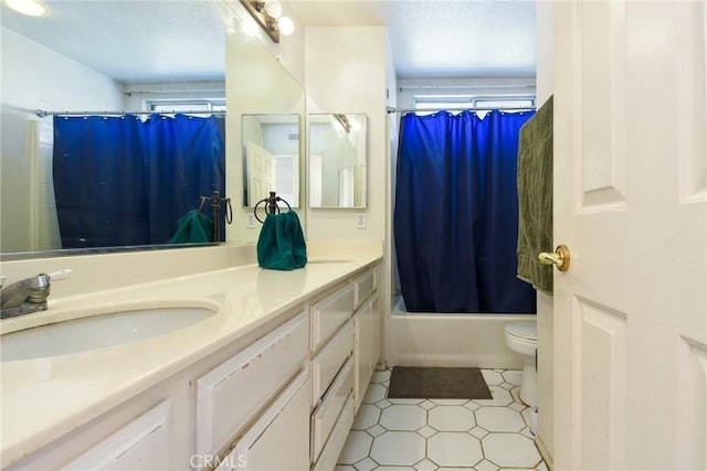 bathroom featuring toilet, shower / tub combo, tile patterned flooring, and vanity