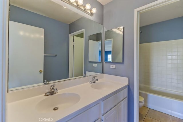 full bath featuring double vanity, tile patterned flooring, a sink, and toilet