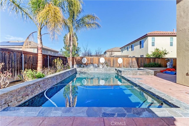 view of swimming pool with a patio, a fenced backyard, and a pool with connected hot tub