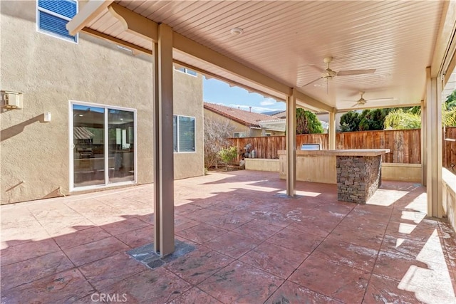 view of patio / terrace with fence and ceiling fan