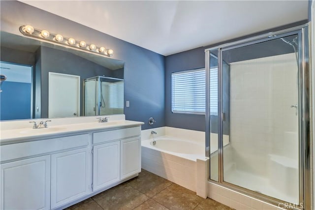 bathroom with double vanity, a sink, tile patterned flooring, a shower stall, and a bath