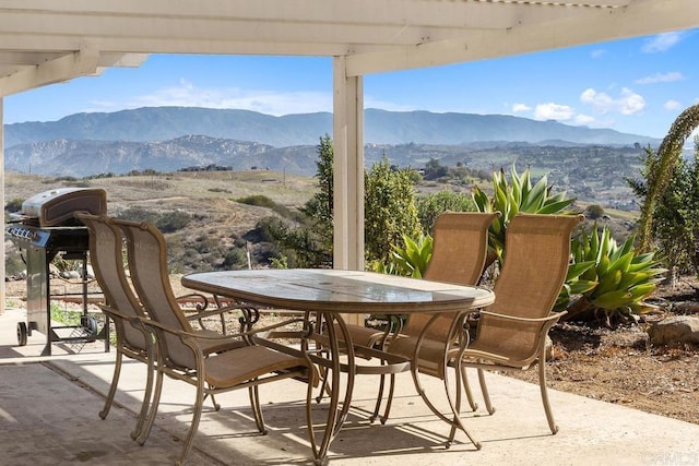 view of patio featuring outdoor dining space and a mountain view