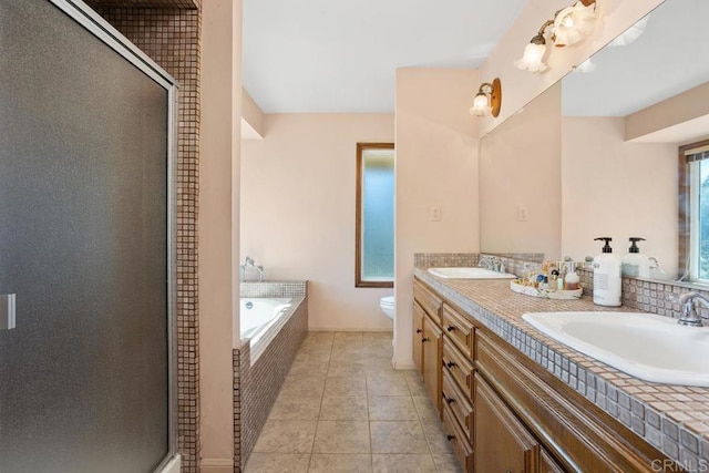 bathroom with a garden tub, a sink, toilet, and a shower stall