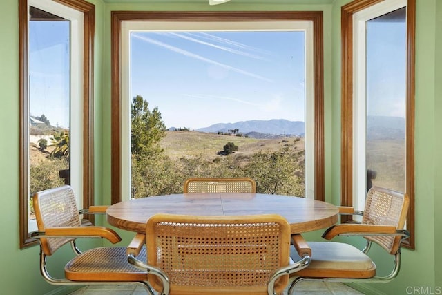 sunroom / solarium featuring a mountain view