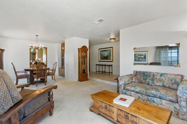 living area with a notable chandelier, visible vents, and light colored carpet