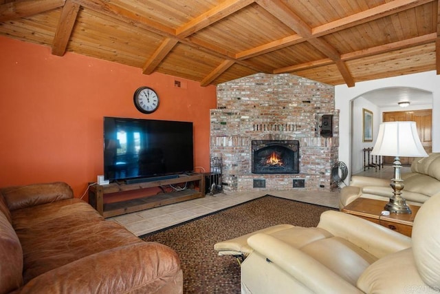 living area featuring arched walkways, wood ceiling, vaulted ceiling with beams, and a brick fireplace