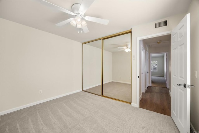 unfurnished bedroom with ceiling fan, a closet, visible vents, and baseboards