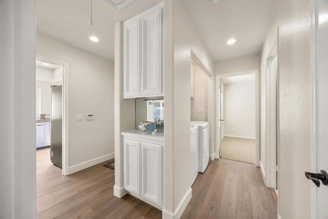 corridor with recessed lighting, separate washer and dryer, baseboards, light wood-type flooring, and attic access