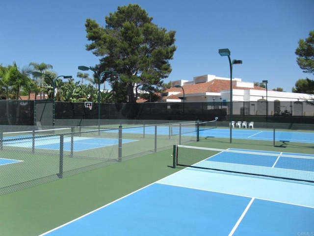 view of tennis court with fence