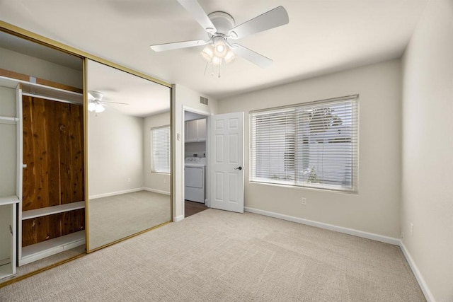 unfurnished bedroom featuring washer / dryer, a closet, and light colored carpet